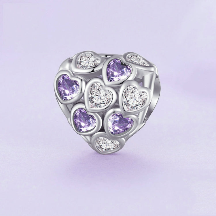 Heart-shaped silver bracelet bead with purple and clear zirconia stones in a cluster design