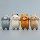 Assorted cartoon cat resin fridge magnets lined up: gray, cream, orange, beige cats.