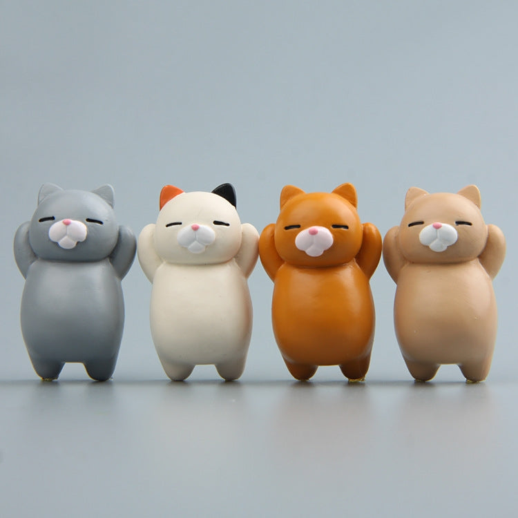 Assorted cartoon cat resin fridge magnets lined up: gray, cream, orange, beige cats.
