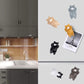 Cat resin fridge magnets attached on a refrigerator with small paper photo clips.