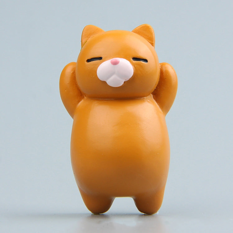 Orange cartoon cat resin fridge magnet, standing figure with pink nose and closed eyes.