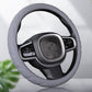 Gray silicone steering wheel cover with textured center panel and wrapped rim