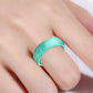 Teal glitter silicone ring, wide band, worn on finger close-up.