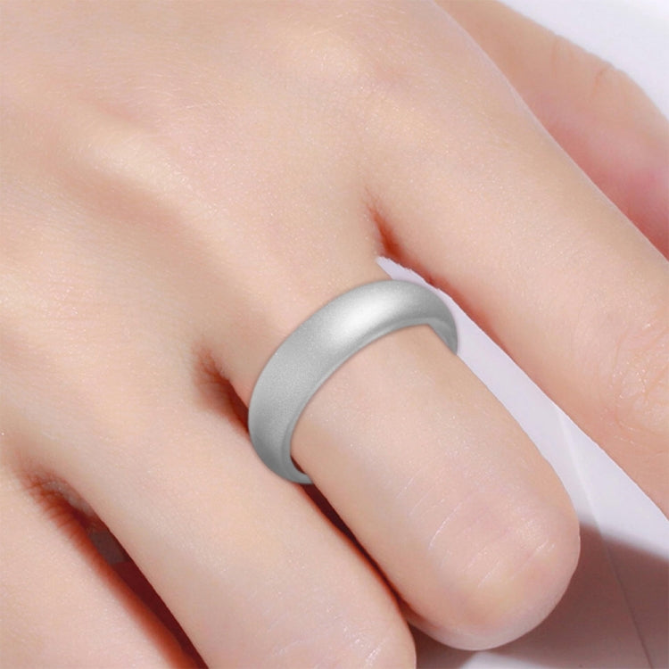 Wide silver-gray silicone glitter ring on finger