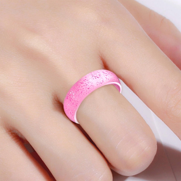 Pink glitter silicone ring, wide band, finger accessory.