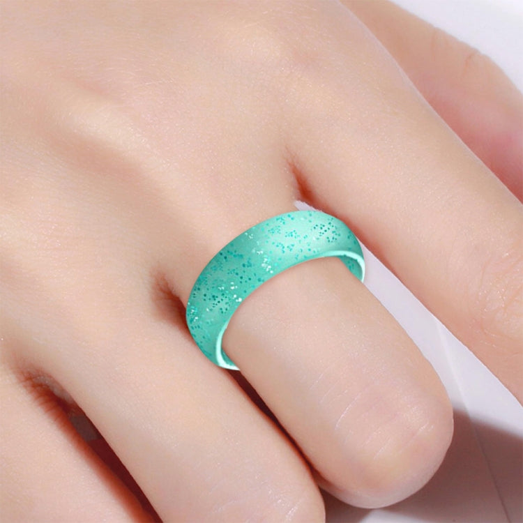Turquoise wide silicone band with glitter specks, worn on finger