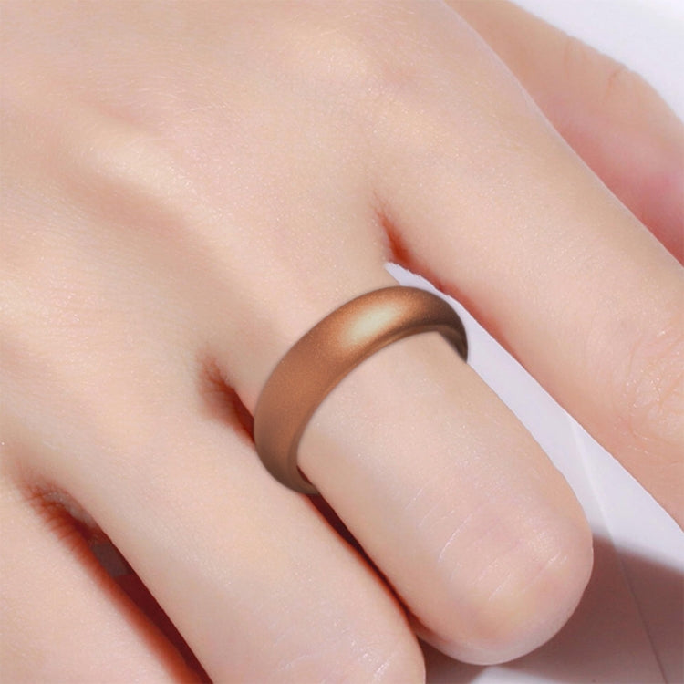 Wide bronze silicone ring band on finger, close-up