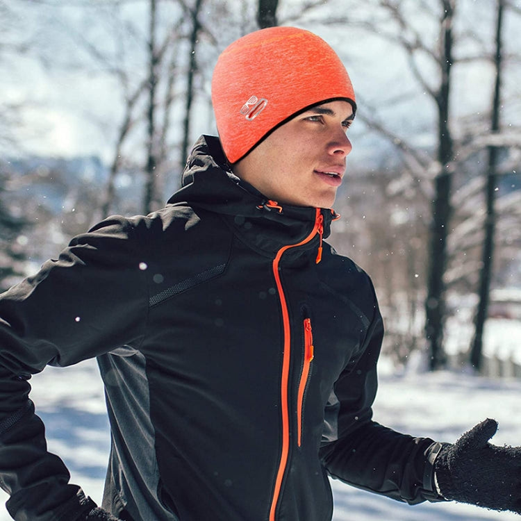 Orange knit winter skull cap worn under a helmet