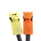 Clock spring connector pairs: white and orange plug housings with wiring