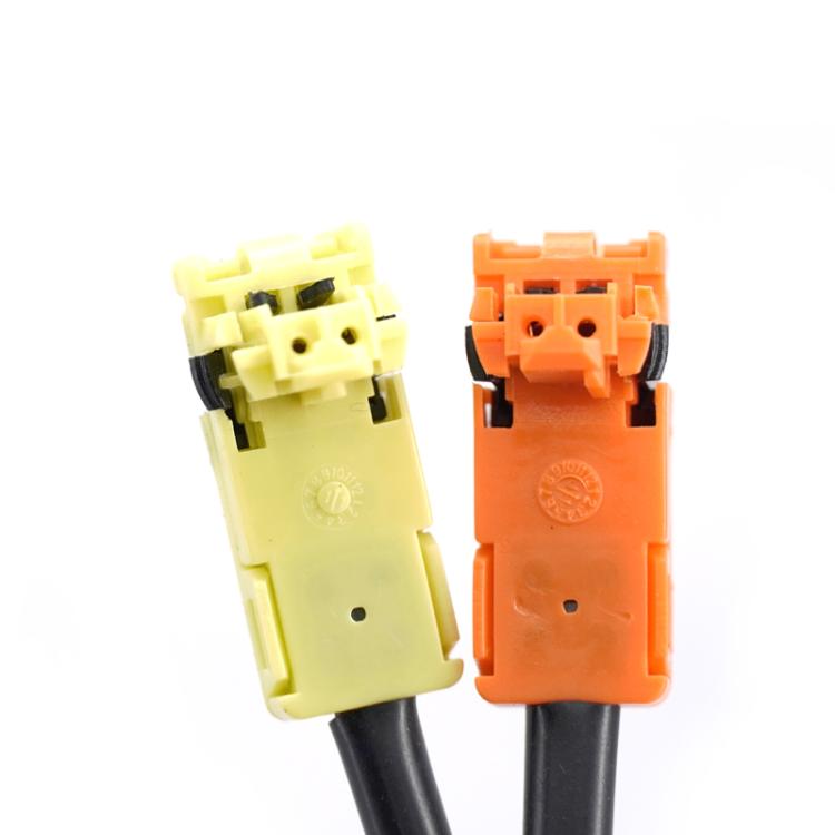 Clock spring connector pairs: white and orange plug housings with wiring