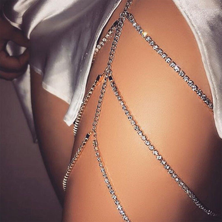 Silver layered thigh chain draped over leg with small sparkling bead links