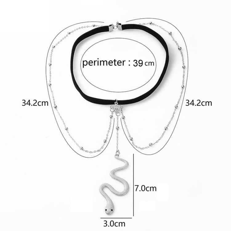 Silver leg chain accessory with black band and dangling snake-shaped charm, flat lay