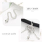 Silver leg chain with black band and snake-shaped charm, shown with packaged accessories