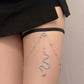 Silver layered thigh body chain with black band and central snake charm on leg