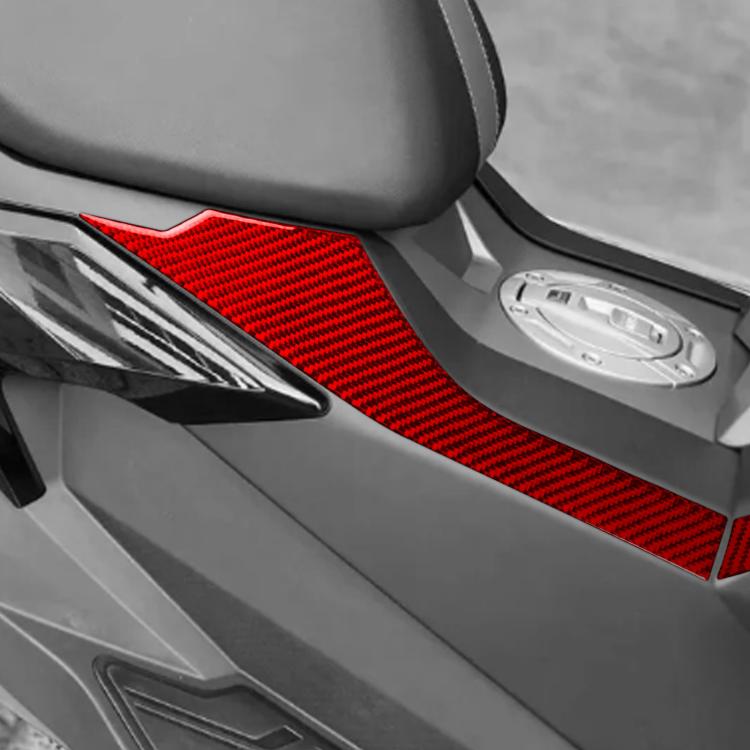 Close-up of red carbon-fiber style fuel tank side stickers on scooter side panel