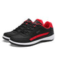 Men's leather casual sneakers in black with red side stripe, lace-up, low profile, white sole