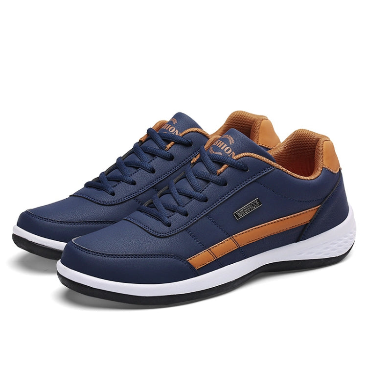 Men's navy low-top leather casual sneakers with tan side stripe and lace-up details