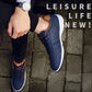 Navy leather sneakers on feet with lace-up design and white rubber sole