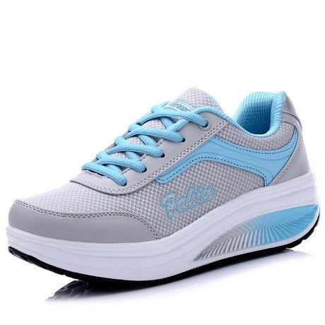 Women's chunky sneakers, gray with light blue laces and thick white sole.