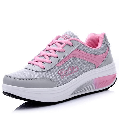 Women's lace-up sport shoes, gray fabric with pink panels and thick white outsole.