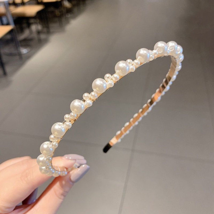 Pearl beaded headband with curved band and black comb, small iridescent bead details