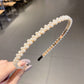 White pearl headband with small bead rows and black grip ends for secure wear