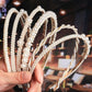 Pearl beaded headband with multiple arched strands and small round faux pearls