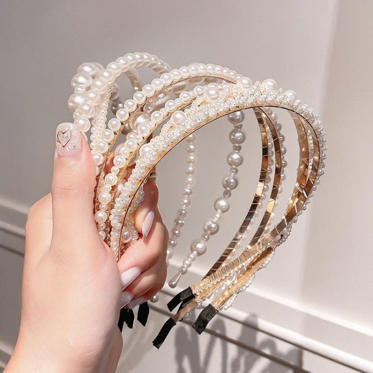 Pearl beaded headband with layered arched bands and metallic gold stripe details