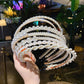 Pearl beaded hair headband with multiple curved bands and small round faux pearls