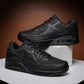 Men's sports shoes, black lace-up sneakers with air-cushioned sole, side view pair