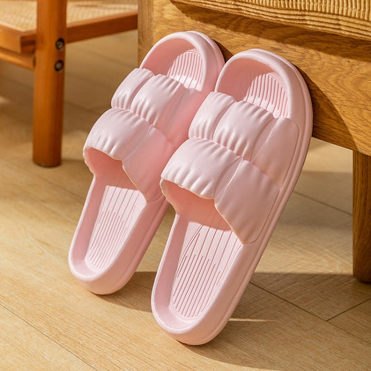 Pair of pink EVA slide slippers with ribbed footbeds and textured anti-slip soles