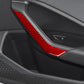 Red carbon-fiber style door armrest decorative stickers installed on car interior panel.