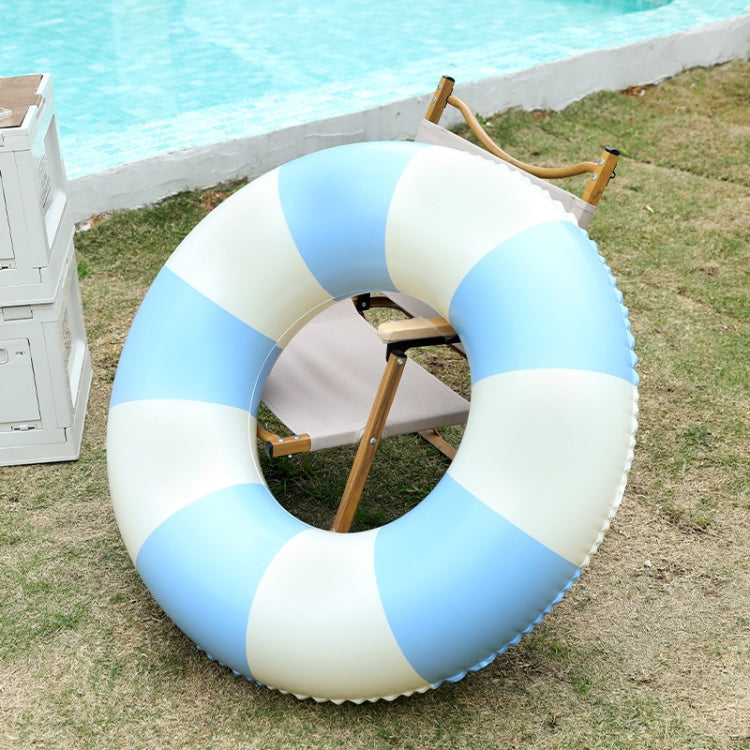 Inflatable child swimming ring, blue and white striped round float, angled view