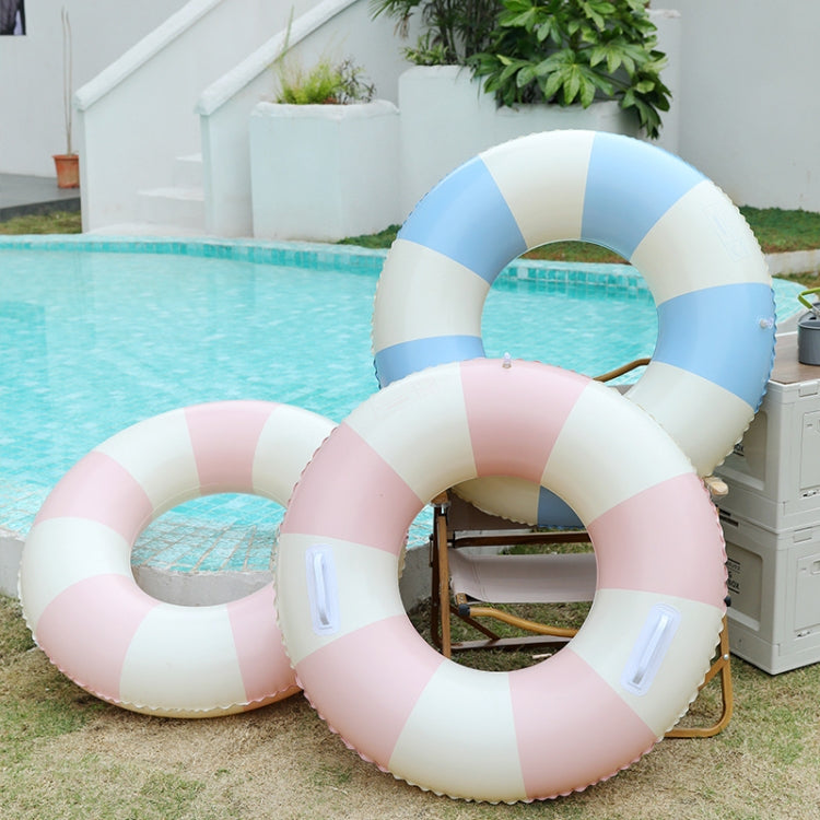 Blue and white striped inflatable kids swimming ring beside a pink striped ring