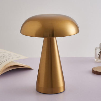 Gold mushroom-style bedside table lamp with rounded dome shade and short tapered stem