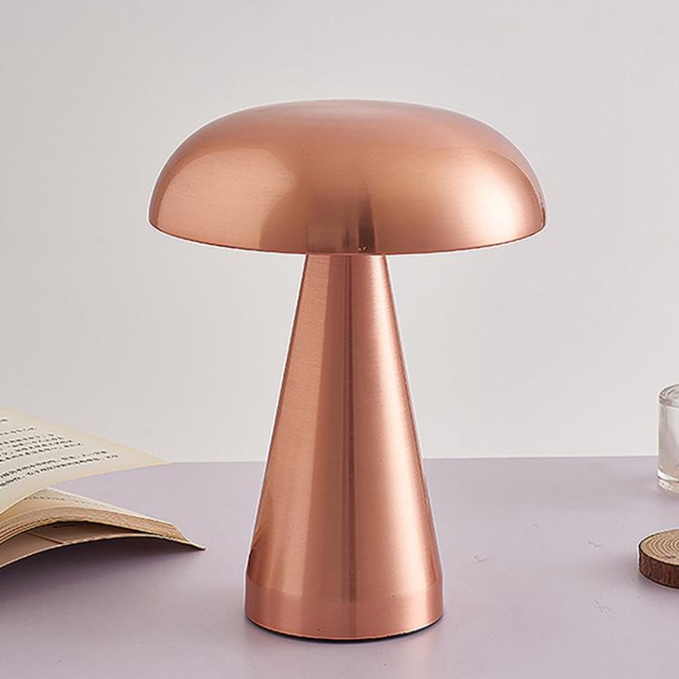 Rose gold mushroom-style bedside table lamp with dome shade and tapered stem