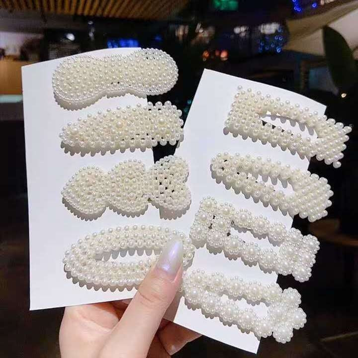 Assorted large pearl hair clips set with scalloped bead bars on packaging cards