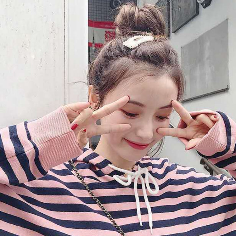 Pearl hair clip barrette holding a high bun on a model