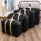 Set of black moving storage duffle bags with beige straps, stacked in multiple sizes