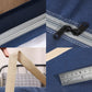 Navy duffel bag corner seam with zipper track and reinforced webbing handle