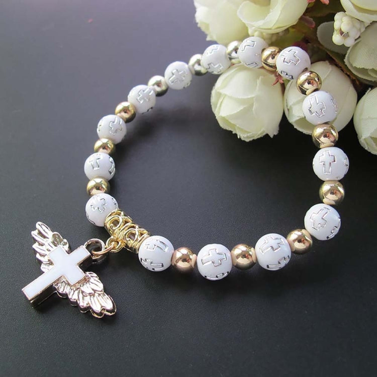 White bead angel cross bracelet with gold spacers and white angel cross charm.