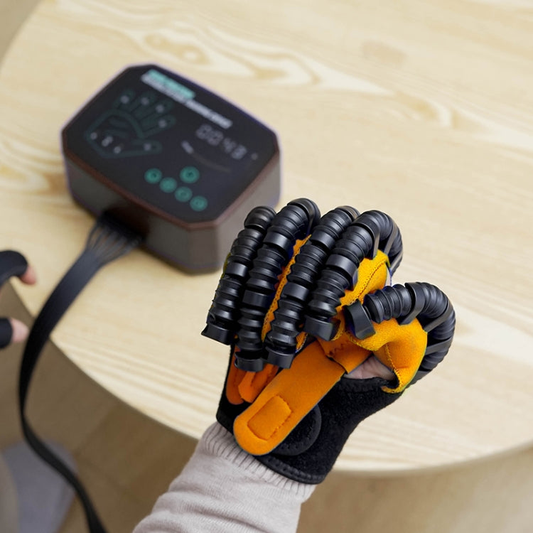 Rehabilitation robotic glove on a hand with black tubing and orange finger pads