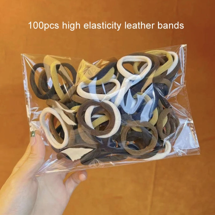 Assorted elastic hair bands in clear bag with black, blue, and white loops