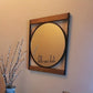 Round vinyl mirror sticker with black cursive “hello sweet cheeks” on a framed mirror