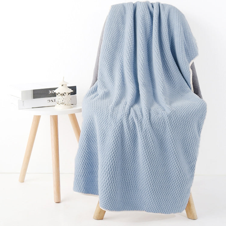 Light blue bath shower towel with waffle texture, side drape view