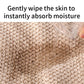 Tan bath towel fabric close-up with textured looped weave