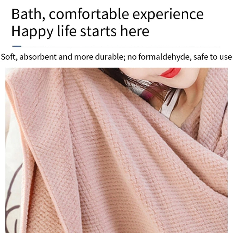 Pink bath towel with textured waffle weave, neatly folded