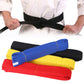 Rolled taekwondo belts in black, blue, yellow, and red