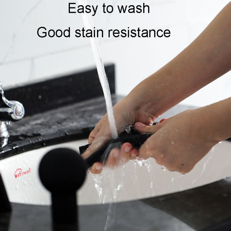 Black silicone handbrake handle cover on a vehicle handbrake, being rinsed with water.