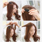 Black sponge hairpin clipped near the hair roots for added height